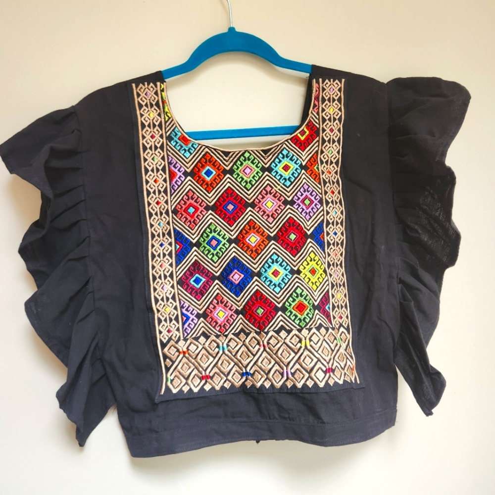 Embroidery top with open back. Size S.